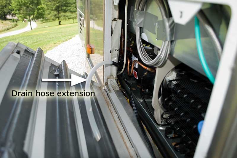 Ahd the drain hose extension peeking out from the rear of the fridge out the vent opening